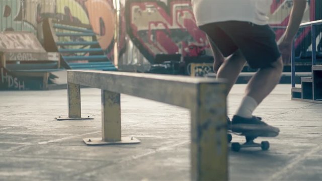 Skateboarder on skate doing slide grind tricks HD video on skateboard park. Urban extreme sport lifestyle