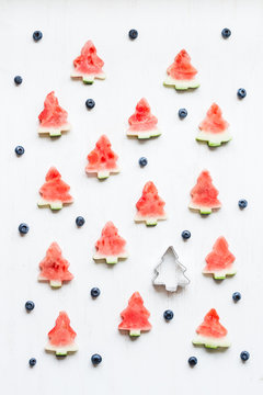 Christmas pattern. Slices of watermelon in the shape of christma