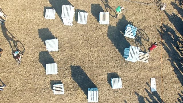 Сyclists doing jump MTB tricks in bicycle 4k aerial top view video. Mountain bike trial rider in park. Extreme sport lifestyle show