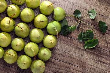Fruit background. Fresh organic pears pattern with green leaves on old wood. Pear autumn harvest