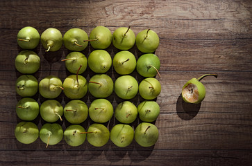 Fruit background. Fresh organic pears pattern with green leaves on old wood. Pear autumn harvest
