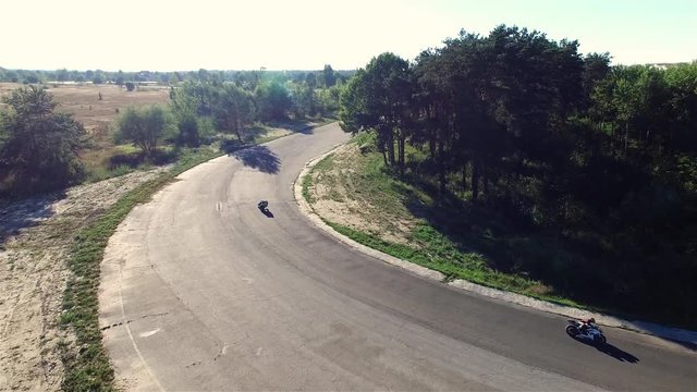 Motorcycle racing 4k aerial video. Moto riders in turn on circuit road track. Extreme sport concept