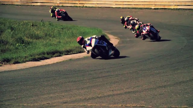 Motorcycle racing HD slow motion static video. Moto riders in turn on circuit road race track. Extreme sport concept
