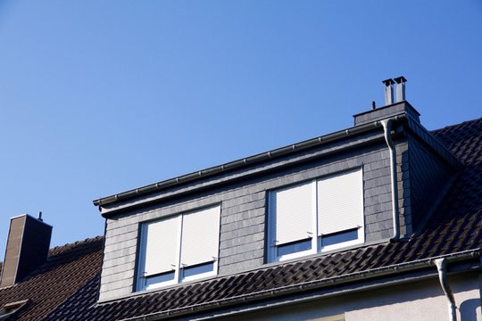 Closeup View On A House With Dormer Windows, Shutter Down