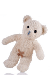 Toy bear with adhesive bandages on his private parts front view