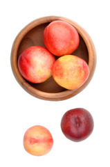 Nectarines in wooden bowl on a white background