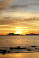 cloudy orange sunset in the beach 