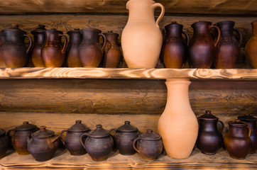 Fototapeta na wymiar clay pots/abundance of clay pots on the top and lower shelf stand in a row