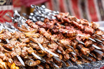 Shish kebab on skewers (beef, pork, chicken) are roasted over th