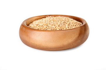 Oatmeal in a wooden bowl on a white background. ingredient for a healthy lifestyle. 