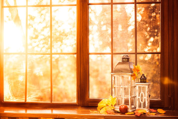 Vintage lanterns at the windowsill. Autumn background