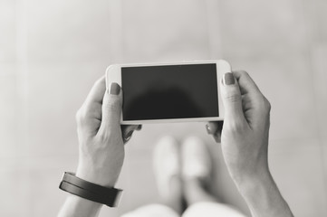 Closeup picture on hand using mobile smart phone, copy space background