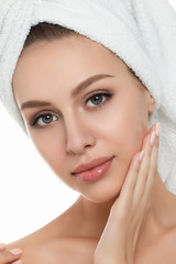 Portrait of young beautiful woman with towel on her hair touchin