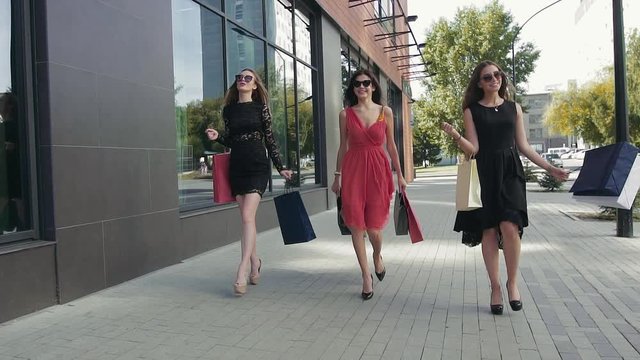 Three young beautiful women enjoying their shopping day together
