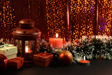Fototapeta na wymiar Christmas gift boxes with lantern and candles 