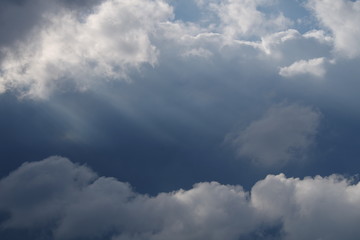 Sad autumn cloud through which the sun's rays make their way