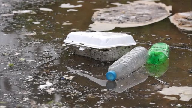 Water pollution - Plastic bottles and foam garbage floating on the surface of the river - Environmental problem caused by human activity