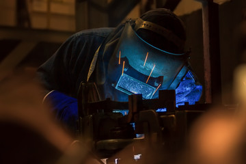 Workers welding work at night in car factory