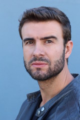 Obraz premium Handsome young trendy man in a gray leather jacket