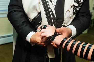 Hand of boy reading the Jewish Torah Bar Mitzvah