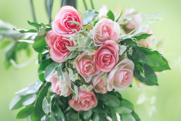Pink fabric rose flowers bouque vintage on green background with