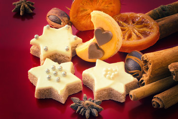 Star Christmas cookies and spices on red background, as a Xmas b
