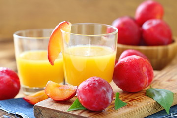 Plum juice and ripe fresh fruit