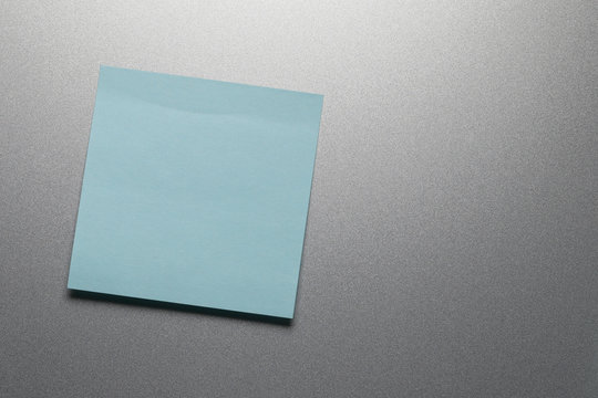 Empty blue paper sheet on refrigerator door.