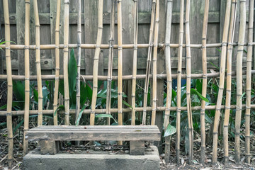 Scenery with the bench / front of bamboo fence