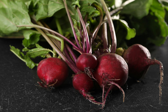 Bunch of fresh beets on black background
