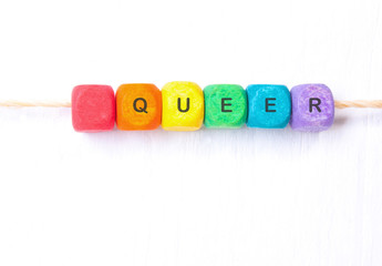 word queer rainbow of colors cubes