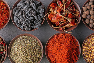 Different spices in bowls on table