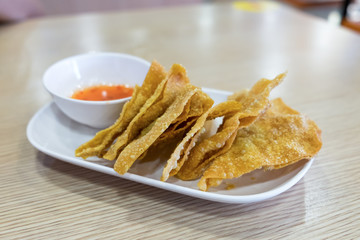 Fried dumplings and sweet sauce on white tray