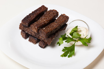 Toasts from black bread and sauce