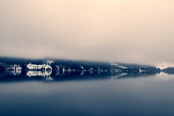Snowy winter landscape on the lake in black and white, on a foggy, cloudy day. Monochrome image filtered in nostalgic, retro, vintage style with soft focus and red filter. - 121774375