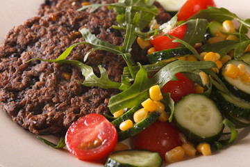 Black bean burger with a salad of fresh vegetables macro horizontal
