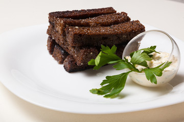 Toasts from black bread and sauce