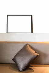 White blank picture frame with pillow decorate on wall bar white