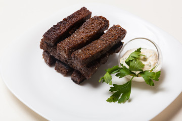 Toasts from black bread and sauce
