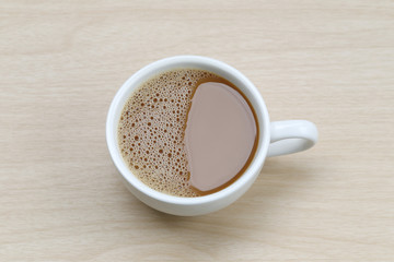 hot coffee in a white Coffee cup on wooden table.