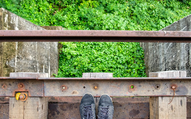 Black sneaker on wooden old railroad of history world war II