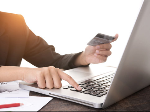 Businessman hands holding credit card with using computer laptop. concept online shopping