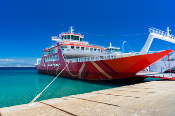 Red ferry boat docked at Limenas on Thassos island, Greece - clear skies, perfect weather, crystal...
