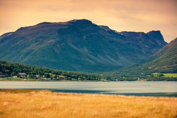 Fototapeta premium The village in a mountain valley is near the fjord