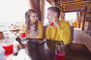 Couple of teenagers in a summer cafe