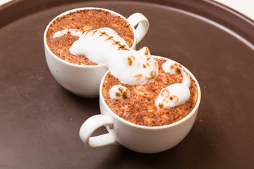 Coffee with foam in the form of cat and mouse