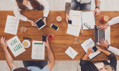 Group of busy business people working in office, top view