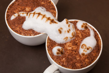Coffee with foam in the form of cat and mouse