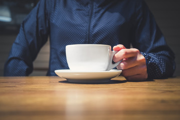 Hipster hand holding Coffee cup on table Cafe restaurant lifesty