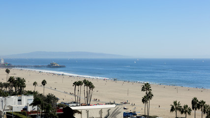 The beach is in the Santa Monica, California. The Pacific Ocean is in the Los Angeles on a Sunny day.